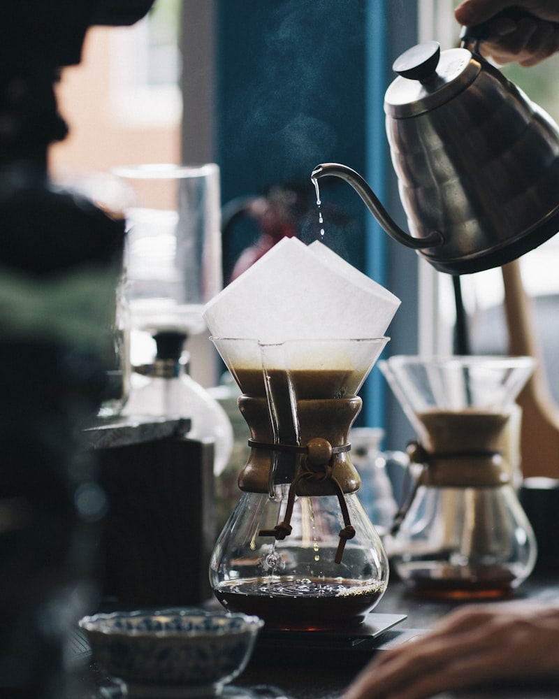 Barista preparing pour-over coffee at Night Owl Coffee Roasters